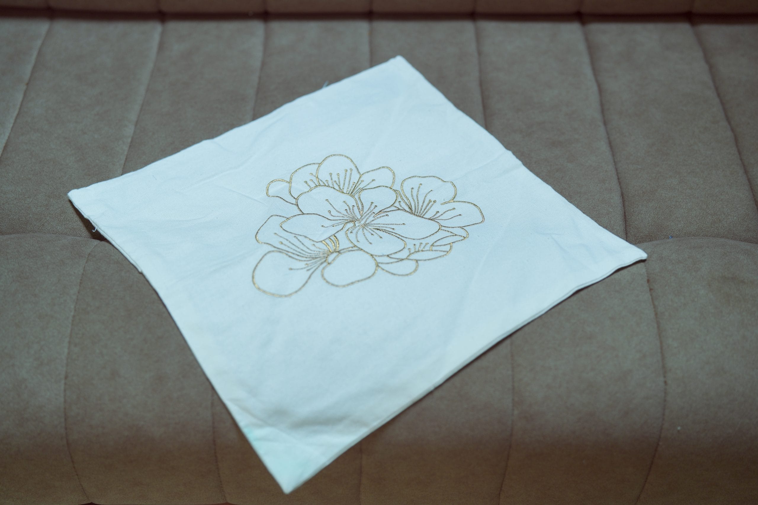 Golden Bloom Off-White Minimal Embroidered Cushion
