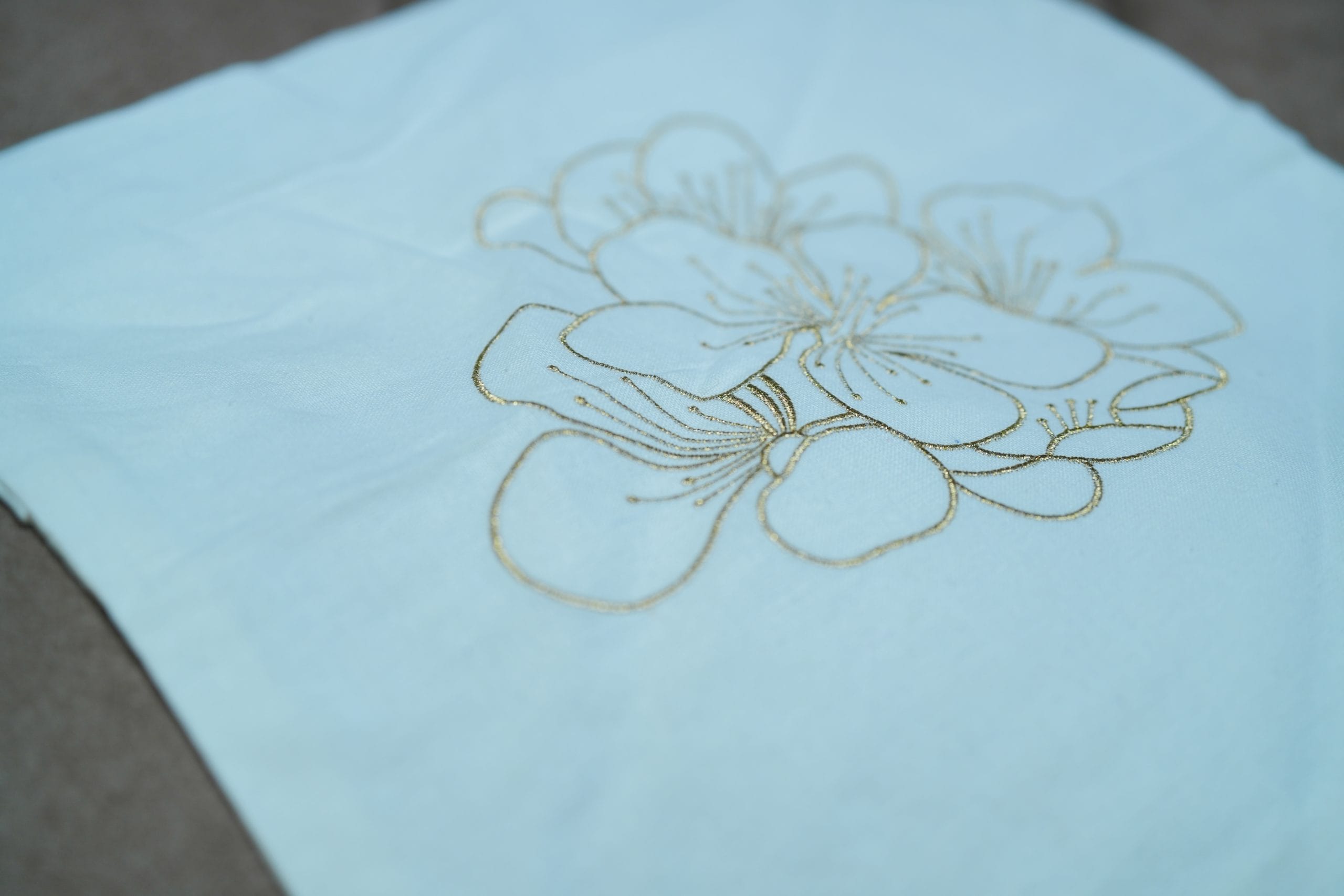 Golden Bloom Off-White Minimal Embroidered Cushion